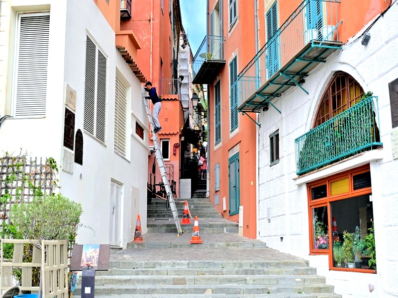Man climbing up ladder on steep steps